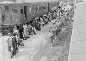 Persons of Japanese ancestry from San Pedro, California, arrive at the Santa Anita Assembly center in Arcadia, California, in 1942. Evacuees lived at this center at the Santa Anita race track before being moved inland to other relocation centers.